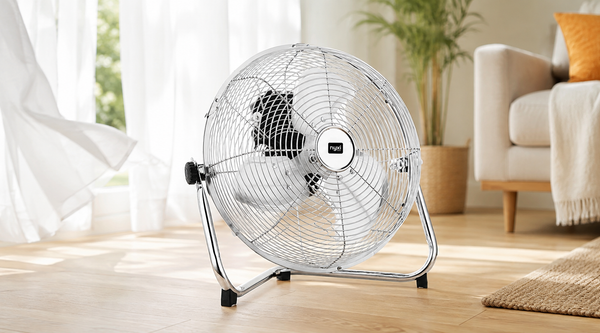 Nyxi branded metal floor fan with chrome grill in a bright summer living room