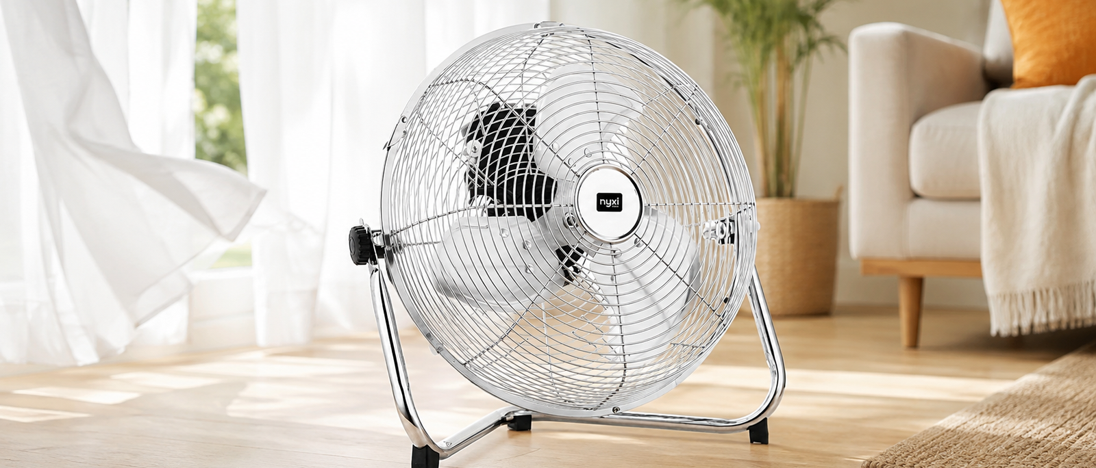 Nyxi branded metal floor fan with chrome grill in a bright summer living room