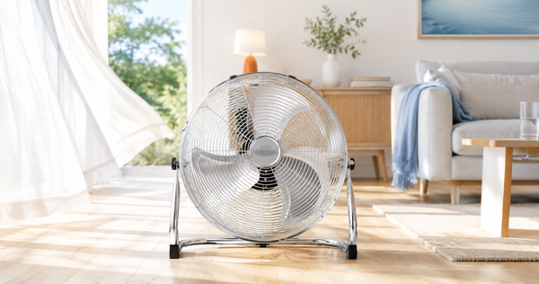 Nyxi metal floor fan with chrome grill in a bright summer living room