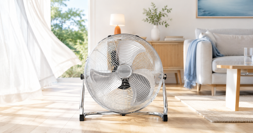 Nyxi metal floor fan with chrome grill in a bright summer living room